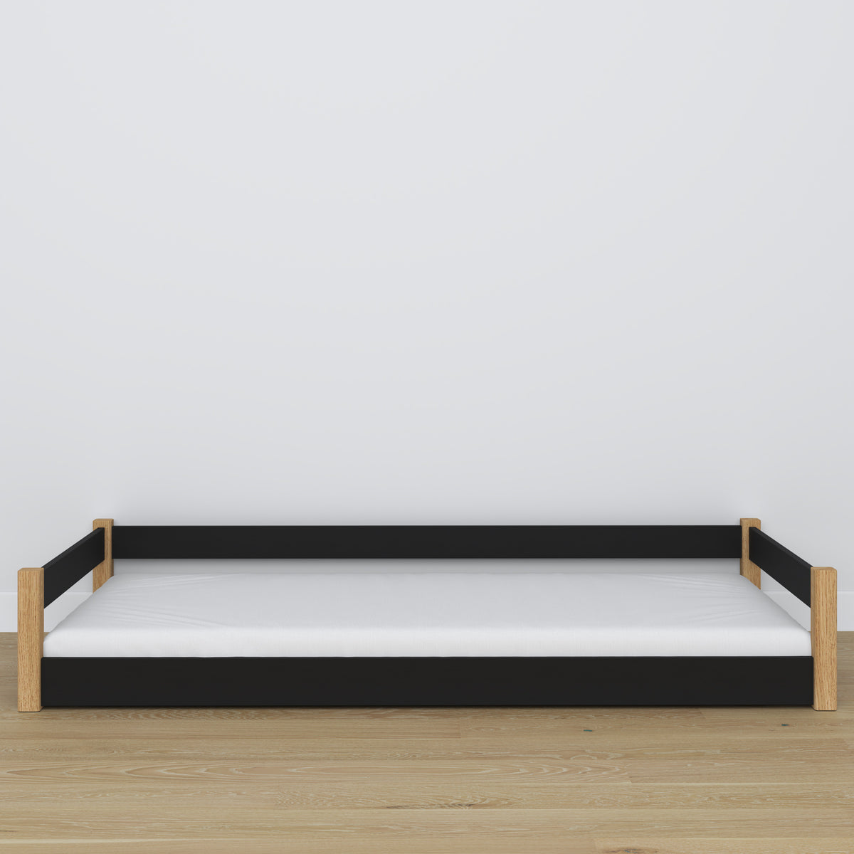 Lit bas en bois noir-chêne – niska rama, vue de côté, chambre scandinave