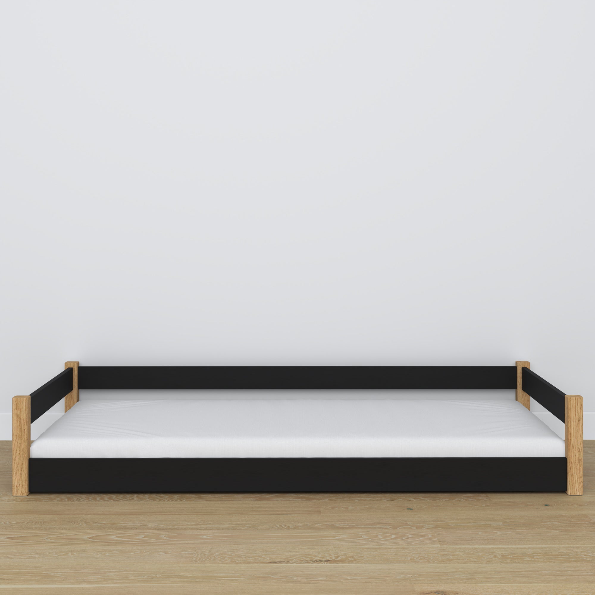 Lit bas en bois noir-chêne – niska rama, vue de côté, chambre scandinave